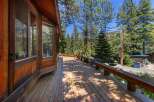 Enjoy the serene mountain lifestyle from this charming cabin's expansive wooden deck, perfect for outdoor relaxation and entertaining.