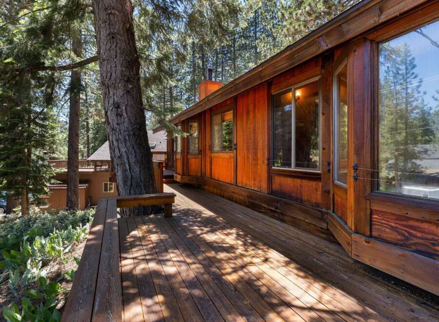 Experience rustic charm and natural beauty with this stunning wooden home nestled amongst tall pine trees.