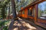 Experience rustic charm and natural beauty with this stunning wooden home nestled amongst tall pine trees.
