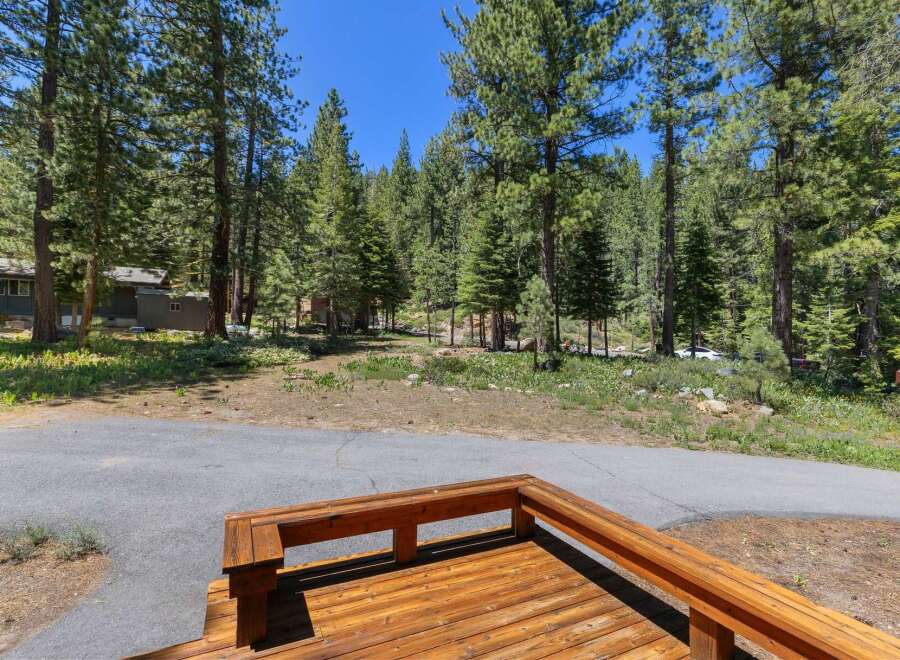 Enjoy the serene mountain lifestyle from this charming property nestled among tall pine trees.