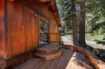 Experience rustic charm with this beautiful wooden cabin, featuring a spacious deck perfect for outdoor relaxation.