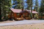 Nestled amidst tall pine trees, this charming wooden cabin offers a serene retreat.
