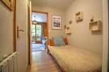 Discover this charming room featuring a cozy single bed adorned with decorative pillows and a plush throw.