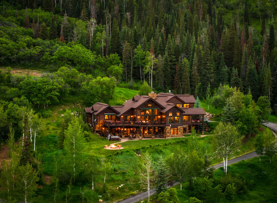 Experience luxury mountain living in this stunning log home nestled amidst a lush forest.