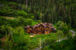 Experience luxury mountain living in this stunning log home nestled amidst a lush forest.