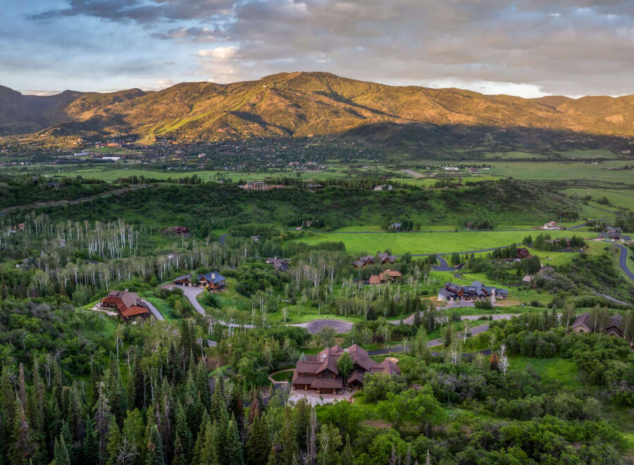 Experience luxury mountain living in this stunning estate, nestled amidst lush greenery and mature trees.