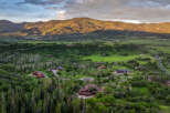 Experience luxury mountain living in this stunning estate, nestled amidst lush greenery and mature trees.