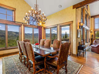 Experience breathtaking mountain views from this elegant dining room, perfect for hosting memorable gatherings.