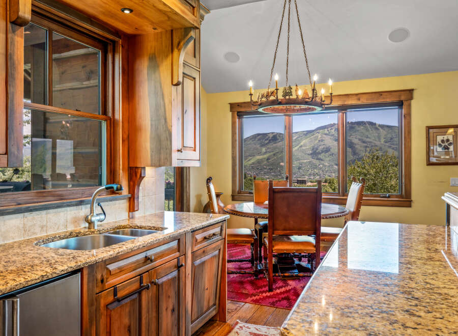 Experience breathtaking mountain views from this stunning kitchen and dining area.