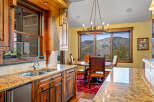 Experience breathtaking mountain views from this stunning kitchen and dining area.