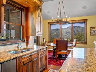 Experience breathtaking mountain views from this stunning kitchen and dining area.
