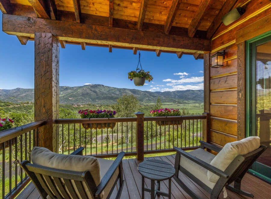 Enjoy breathtaking mountain views from this charming covered porch, perfect for relaxing with a morning coffee or evening drink.