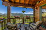 Enjoy breathtaking mountain views from this charming covered porch, perfect for relaxing with a morning coffee or evening drink.