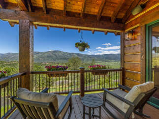 Enjoy breathtaking mountain views from this charming covered porch, perfect for relaxing with a morning coffee or evening drink.