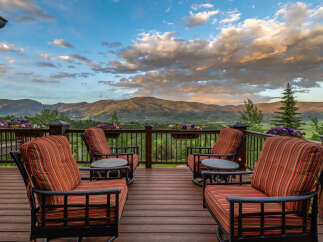 Experience breathtaking mountain views from this stunning deck, perfect for enjoying serene sunsets and crisp morning air.
