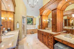 Indulge in luxury in this stunning bathroom featuring a spacious walk-in shower and a deep soaking tub with a scenic window view.