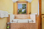 Indulge in relaxation in this luxurious bathroom featuring a deep soaking tub, perfect for unwinding after a long day.