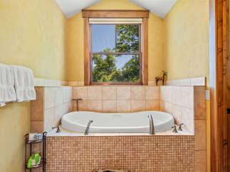 Indulge in relaxation in this luxurious bathroom featuring a deep soaking tub, perfect for unwinding after a long day.