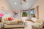 Experience serene mountain living in this charming bedroom, featuring a plush king-sized bed adorned with decorative pillows and a cozy throw.