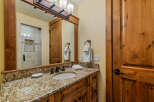 This bathroom showcases a beautiful granite countertop with an undermount sink and oil-rubbed bronze fixtures.