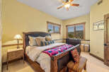 Experience luxury mountain living in this exquisite bedroom, featuring a grand wooden sleigh bed adorned with plush pillows and a vibrant, patterned throw.