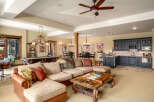 This spacious basement living area offers a perfect blend of entertainment and relaxation, featuring a full-size pool table and a cozy sectional sofa.