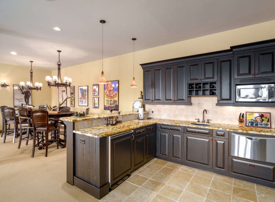 Experience luxury and entertainment in this stunning basement bar and kitchen area.