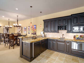 Experience luxury and entertainment in this stunning basement bar and kitchen area.