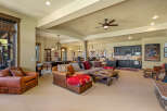 This spacious entertainment area features a large sectional sofa, a pool table, and a full bar with a microwave and mini-fridge.