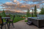 Experience luxury outdoor living with this stunning property featuring a relaxing hot tub and a cozy fire pit, perfect for enjoying breathtaking mountain views.