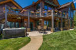 Experience luxury mountain living with this stunning log home, featuring expansive decks and a private hot tub perfect for relaxation.