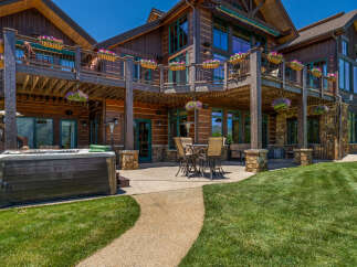 Experience luxury mountain living with this stunning log home, featuring expansive decks and a private hot tub perfect for relaxation.