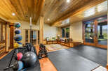 This home gym features a variety of equipment, including medicine balls, dumbbells, and a barbell, perfect for a full-body workout.