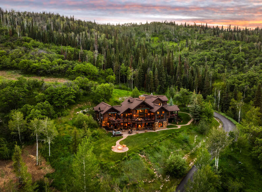 Experience luxury mountain living in this stunning log home nestled amidst a lush forest.