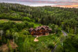 Experience luxury mountain living in this stunning log home nestled amidst a lush forest.