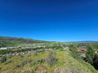 Discover this charming property nestled in a picturesque valley, offering breathtaking panoramic views of rolling green hills and distant mountains.