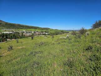 Discover this expansive parcel of land offering breathtaking panoramic views of the surrounding mountains and valley.