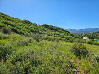 Discover breathtaking natural beauty with this stunning property offering panoramic views of lush green hills and distant mountains.