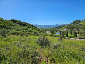 Discover breathtaking mountain views from this stunning property, nestled amidst lush greenery and rolling hills.