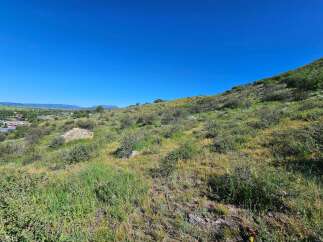 Discover this stunning property offering breathtaking panoramic views of the surrounding valley and distant mountains.
