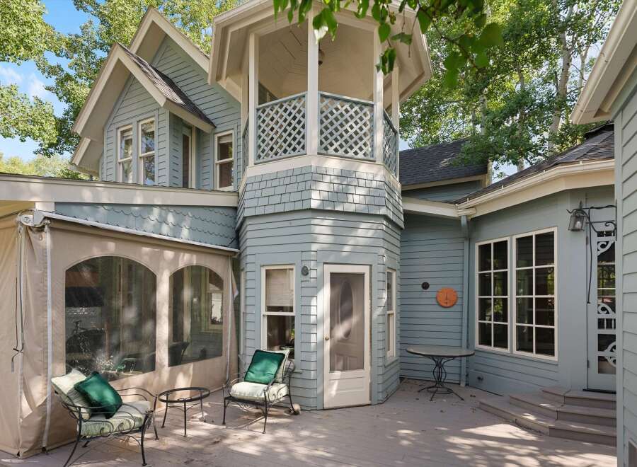 Enjoy outdoor living on this charming deck, complete with comfortable seating and a small table, perfect for morning coffee or evening relaxation.