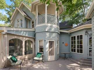 Enjoy outdoor living on this charming deck, complete with comfortable seating and a small table, perfect for morning coffee or evening relaxation.