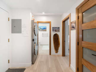 Discover modern living in this hallway featuring a stacked washer and dryer for ultimate convenience.