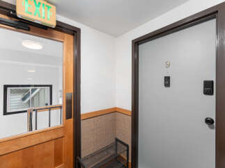 Discover modern living with this secure apartment entrance, featuring a smart lock and doorbell for enhanced safety.