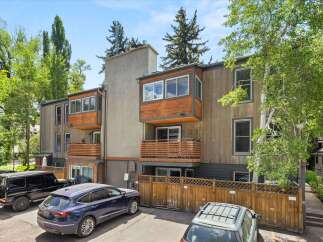 Discover modern living in this multi-level townhome featuring a striking facade with wood and stucco accents.