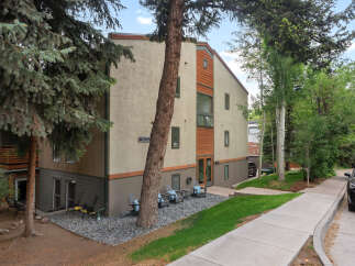 Discover modern living in this multi-story residence featuring a stucco exterior with wood accents and a sloped roof.