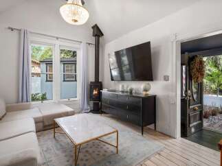Cozy living room featuring a plush sectional sofa, a marble-top coffee table, and a modern wood-burning stove for warmth.
