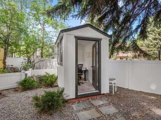Discover this charming backyard office, a perfect retreat for focused work or creative endeavors.