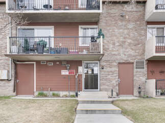 Discover comfortable living in this brick apartment building featuring multiple balconies with railings and exterior doors.