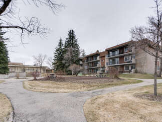 Discover comfortable living in this multi-story apartment building featuring private balconies and ample green space.